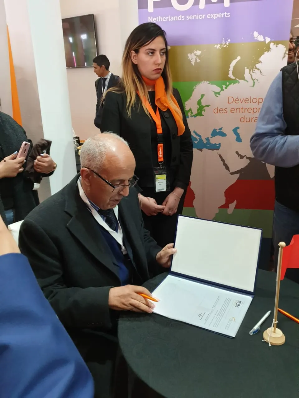Le président de l'association signe un accord sur le stand de PUM Netherlands senior experts